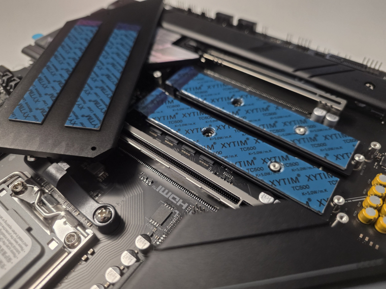 A leszerelt M.2 hűtőborda alatt jól látható a gyárilag felhelyezett hővezető pad, amely hatékonyabb hőátadást biztosít a PCIe 5.0-s NVMe SSD-k és a hűtőborda között. A Gen5 és Gen4 M.2 foglalatpárok mellett két SATA-port is rendelkezésre áll, így adattárolás terén kevés hiányérzeted lehet - hacsak nem vagy eleresztve SATA-meghajtókkal